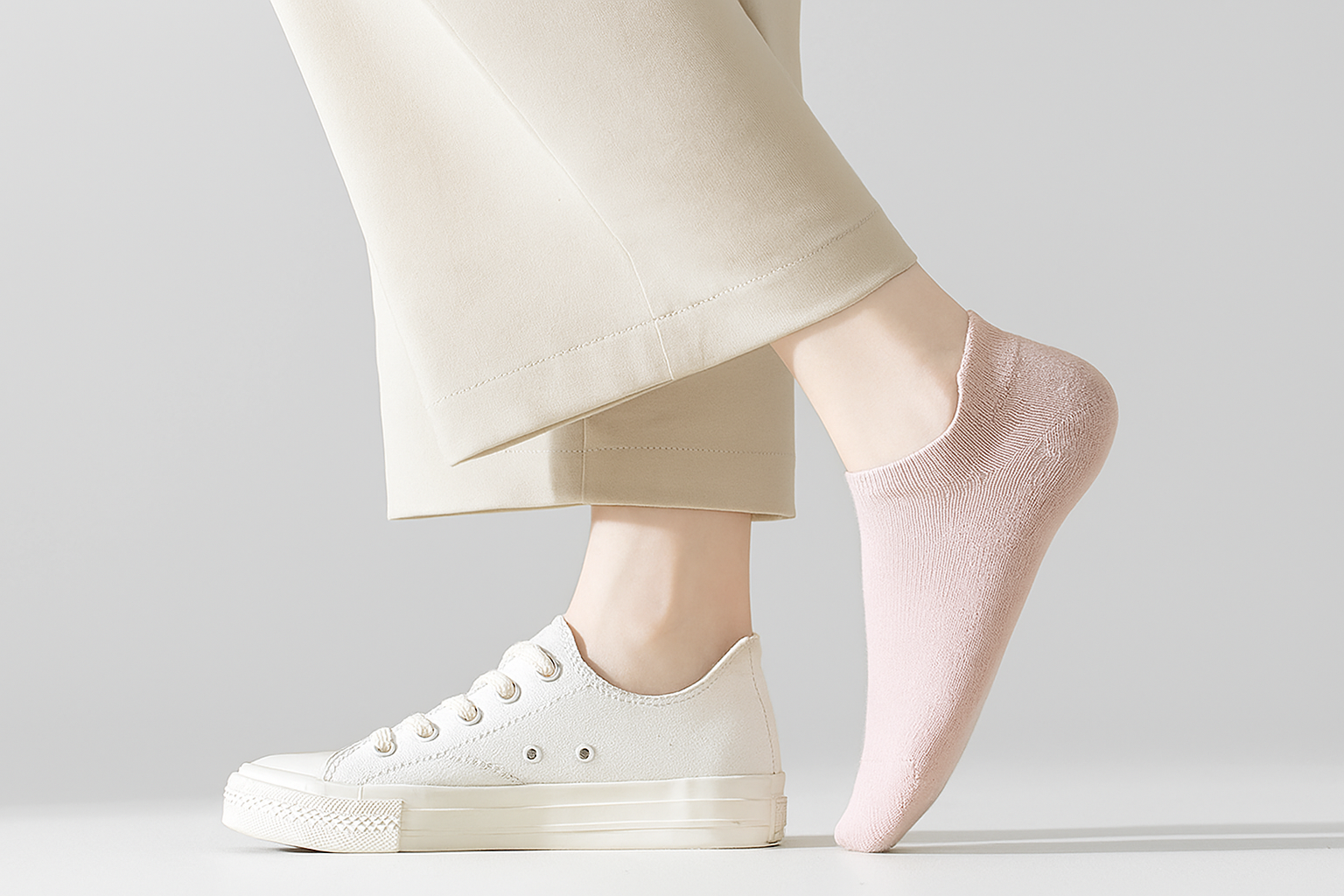 Close-up of pink ankle socks styled with white sneakers